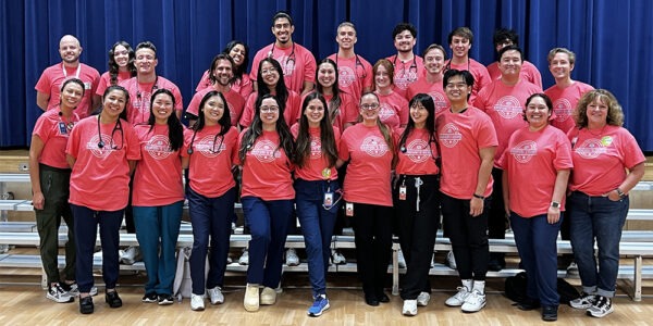 a group photo of all of the volunteers working at the free health screening